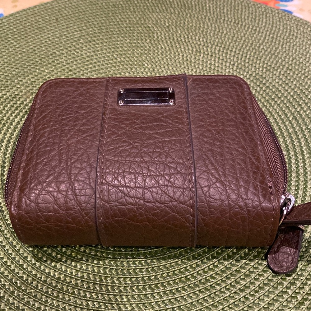Wallet 5.5x 4” with 2 sides with zippers. Imitation leather.Maybe?